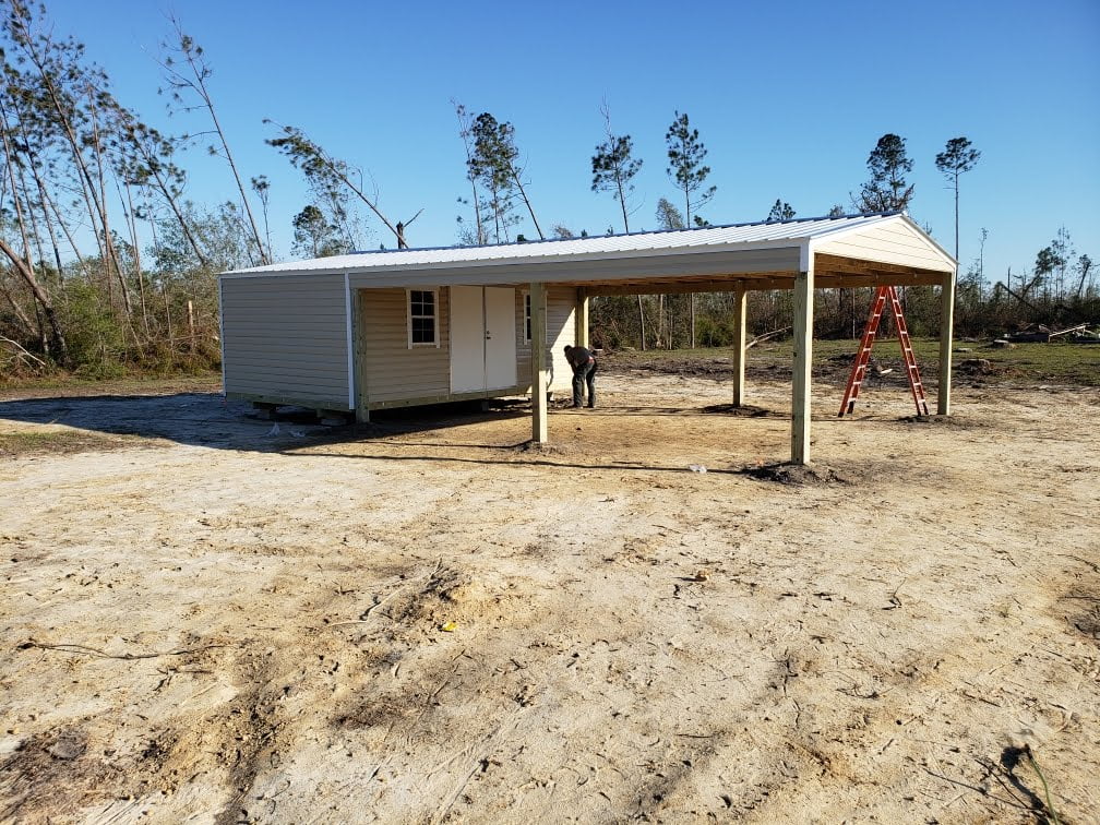 12X20 PORBALE BUILDING WITH A 20X24 DOUBLE CARPORT