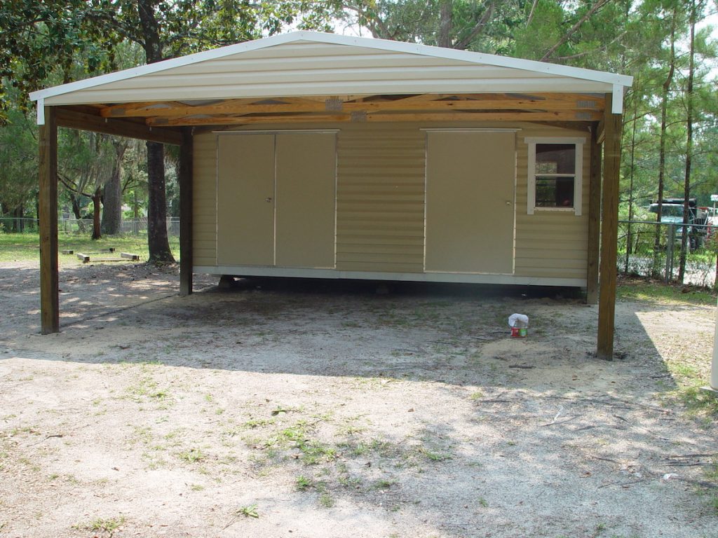 16X20 PORTABLE WITH 16X20 CARPORT AND 2 DOORS