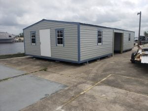 two 16x20 sheds with carport in the middle