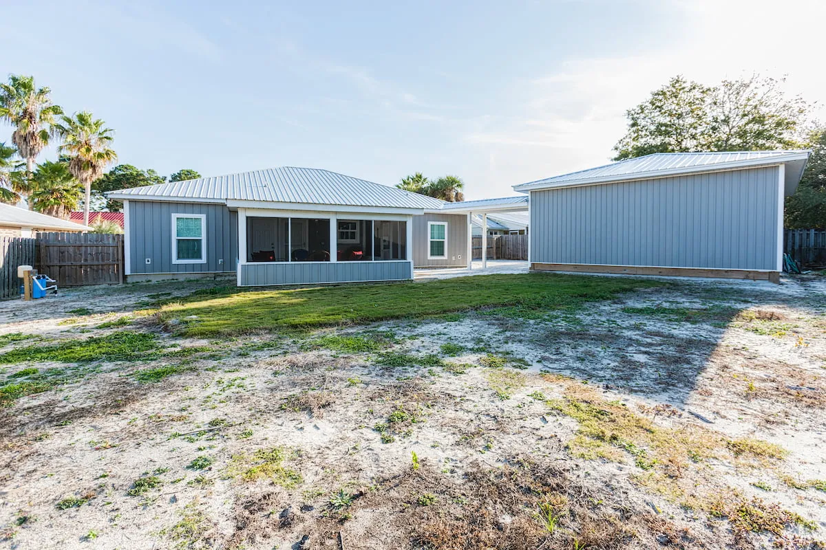 BACK YARD VIEW OF SCREEN ROOM AND GARAGE